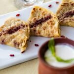 Indian stuffed flatbread served with yogurt