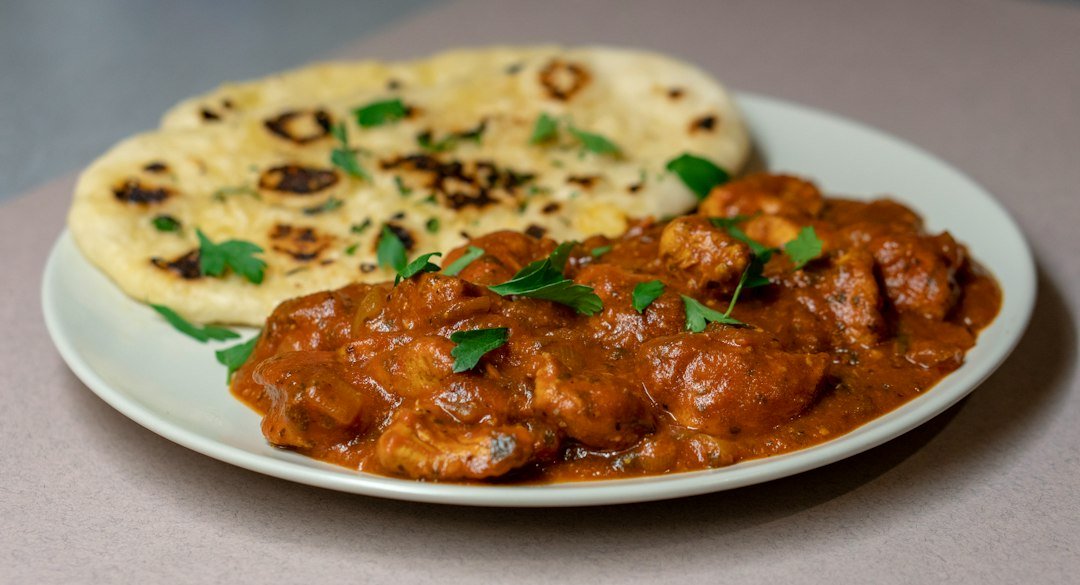 Indian chicken curry served with roti; illustrative image for Andhra chicken curry recipe