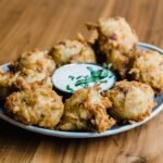 Golden Indian onion pakora fritters served on a plate