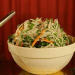 Colorful Indian-style fresh vegetable salad with grated vegetables and herbs