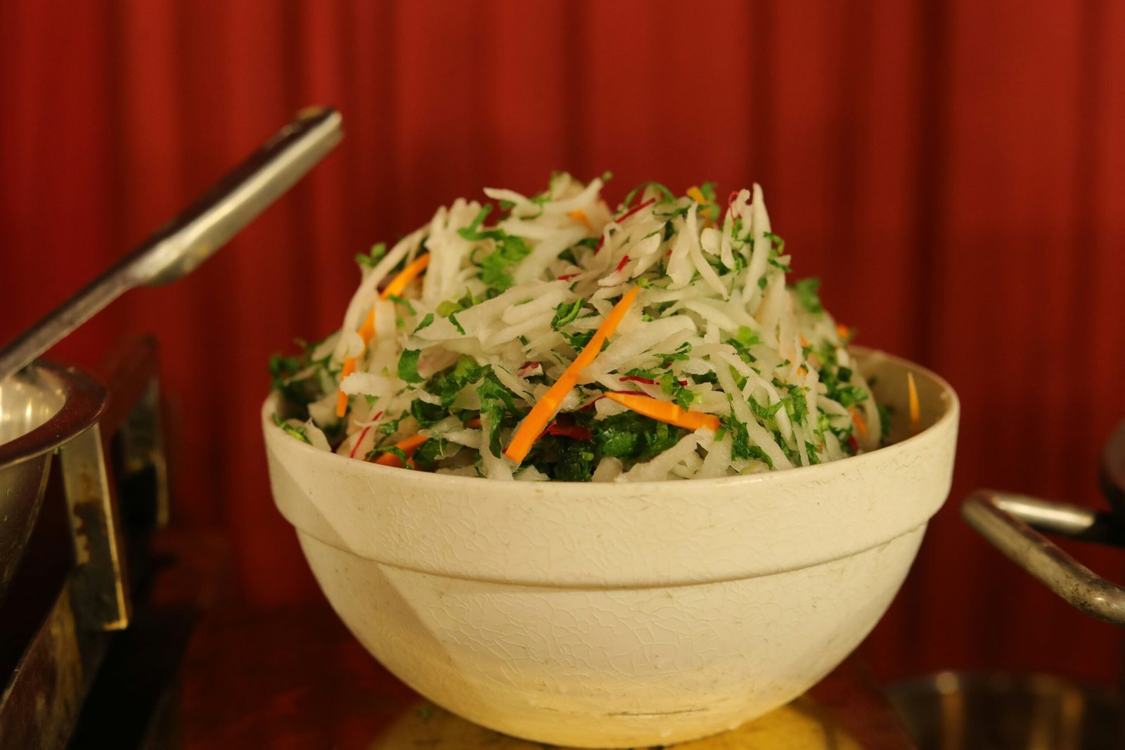 Colorful Indian-style fresh vegetable salad with grated vegetables and herbs