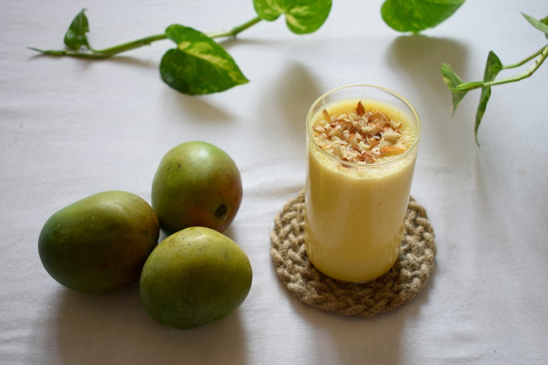 Mango drink in a glass as an illustrative image for mango lassi