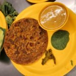 Indian flatbread served with spices; illustrative image for pesarattu recipe