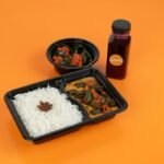 Rice and vegetables packed in a food container; illustrative stock photo for vegetarian lunch box ideas